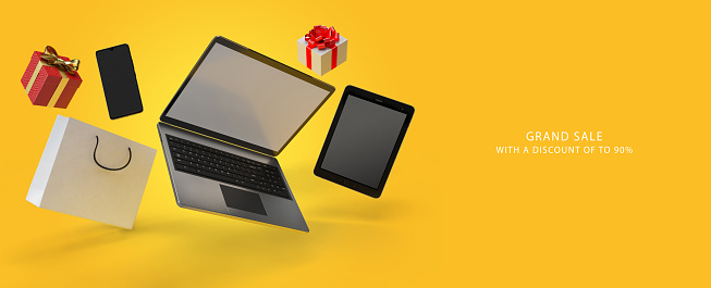 Online shopping concept desktop with computer, table, shopping bags, smartphone or cellphone, present box and products on yellow background banner size with Grand Sale Text 3d rander.