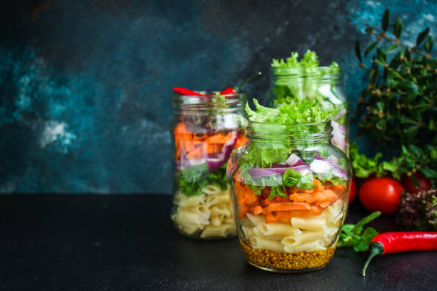 istock healthy salad in a jar (vegetable snack pasta salad) menu concept. food background. top view. copy space 1205511787