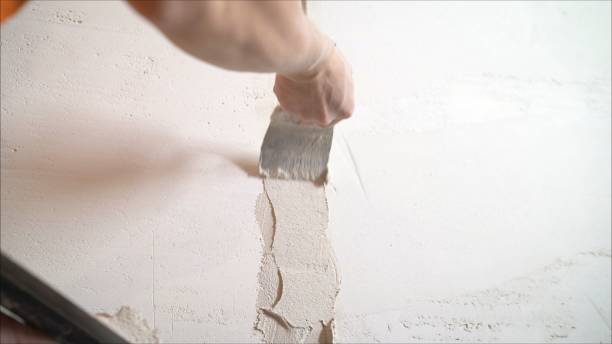istock Plasterer putting plaster on wall. Worker covers the wall with mortar. 1205512981
