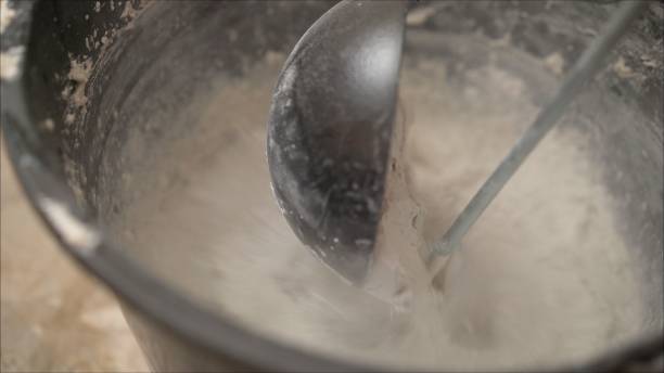 istock mortar will be puddled with water and an stirrer. Construction putty is mixed with water. 1205513262
