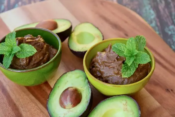 Vegan avocado chocolate mousse garnish with mint leaf