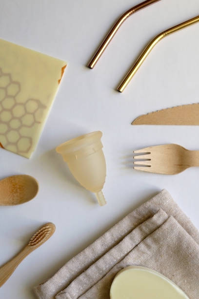 Zero Waste Kit Various zero waste products on a white background: cloth, soap, cutlery, straws, toothbrush and menstrual cup. Top view. beeswax wrap stock pictures, royalty-free photos & images