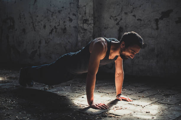 istock Athletic Young Man Exercise In Old Factory Building 1205516053
