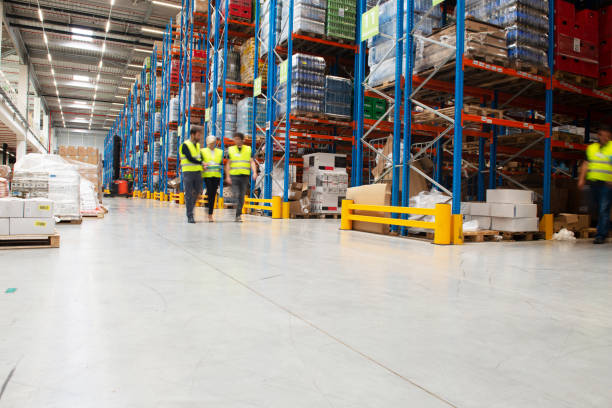 istock Managers in Warehouse discuss about business 1205523870