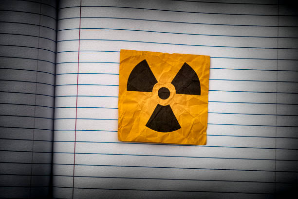 Radiation warning sign on a lined paper. Close up.