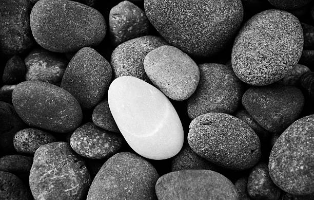 istock Group of rocks that are grey and one white rock on top 120552814