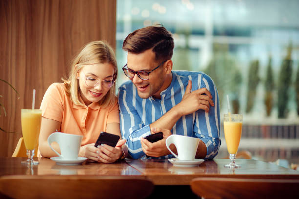 istock Two friends having fun ina coffee shop 1205528996