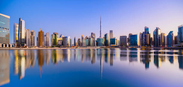 Panoramic View of the Downtown Dubai City Skyline and Business Park at Sunset, United Arab Emirates Reflections in the Still Waters, Copy Space dubai skyline stock pictures, royalty-free photos & images