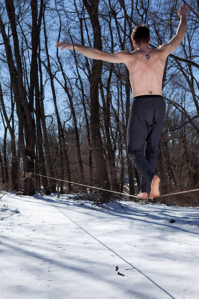 Walking a Slackline over Snow stock photo