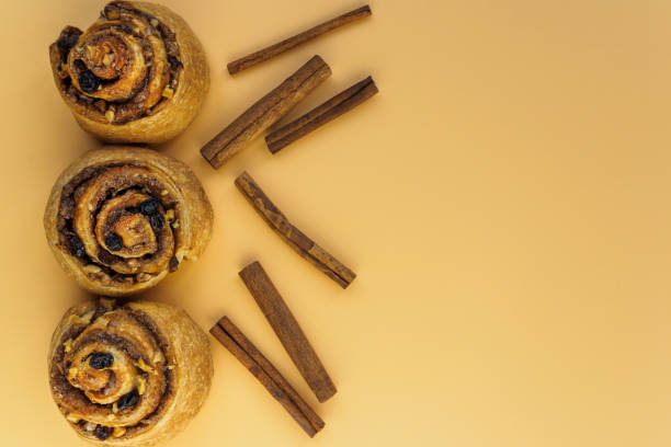 istock Buns with nuts, raisins and cinnamon on orange background with copy space 1205532992