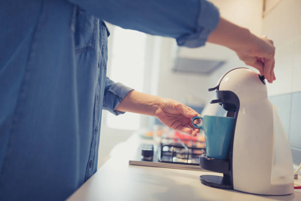 istock Young woman is making her morning coffee in her kitchen 1205533340