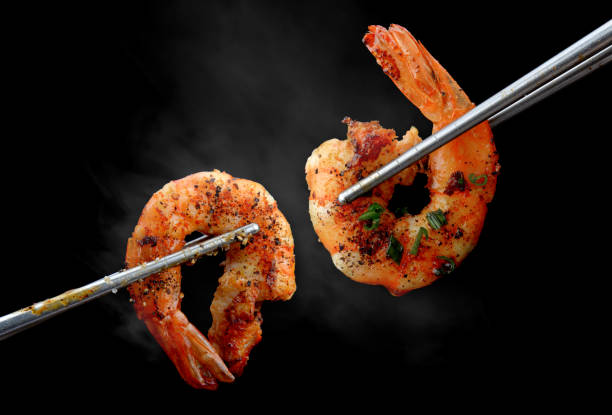 istock Grilled shrimps prawn with chopsticks. 1205536616