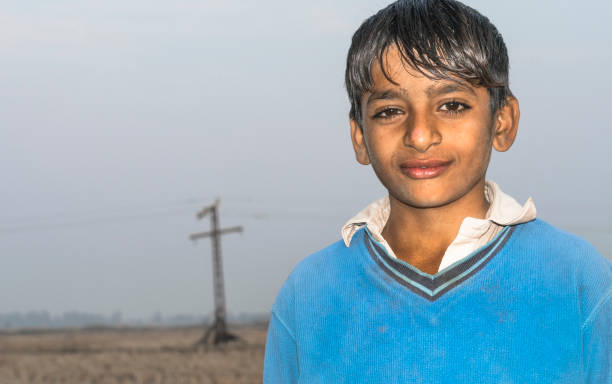 istock a young an innocent orphan student boy is smiling 1205539154