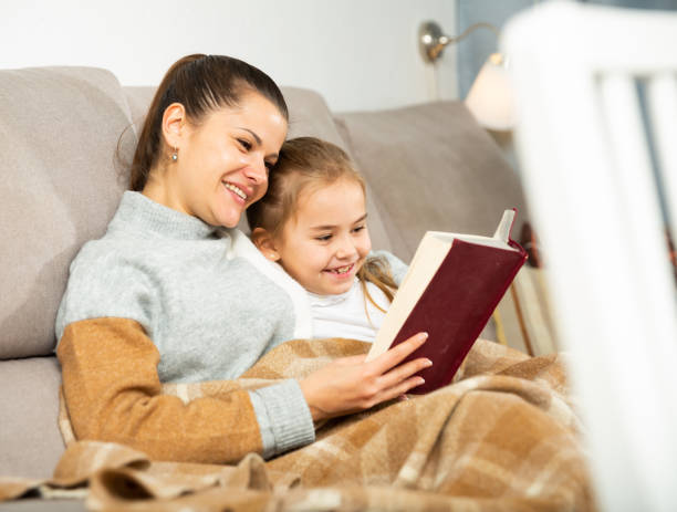 istock Mother reads an interesting book for her small daughter 1205540462