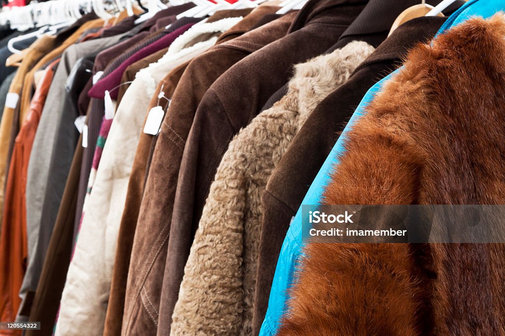 Closeup secondhand winter coats and jackets hanging in shop Close up secondhand winter coatsand jackets hanging the shop, full frame horizontal composition Animal Hair Stock Photo