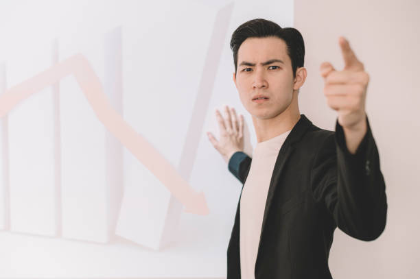 istock an asian chinese young white collar worker frustrated with his business negative forecast result during the meeting with projection on the wall 1205543854