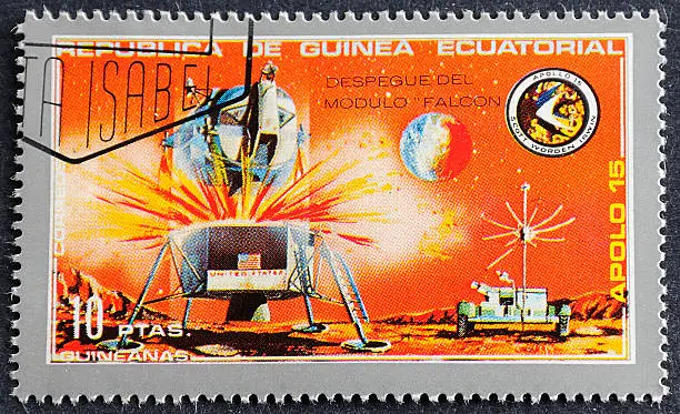 Photograph of a canceled  postage stamp from Republica De Guinea commemorating the Apollo 15 Space Mission shot on black background.