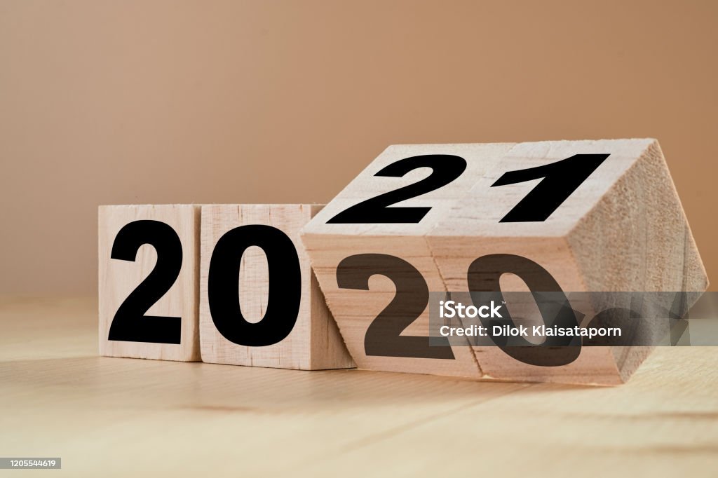 Flipping wooden cubes for new year change 2020 to 2021. New year change and starting concept. 2021 Stock Photo