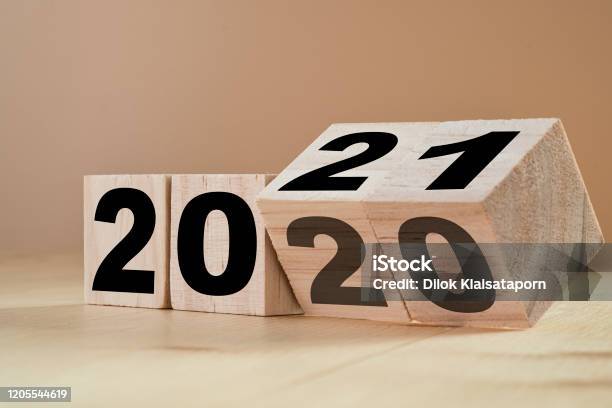 Flipping Wooden Cubes For New Year Change 2020 To 2021 New Year Change And Starting Concept Stock Photo - Download Image Now