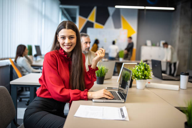 istock Happy, young IT professional at her desk 1205544967