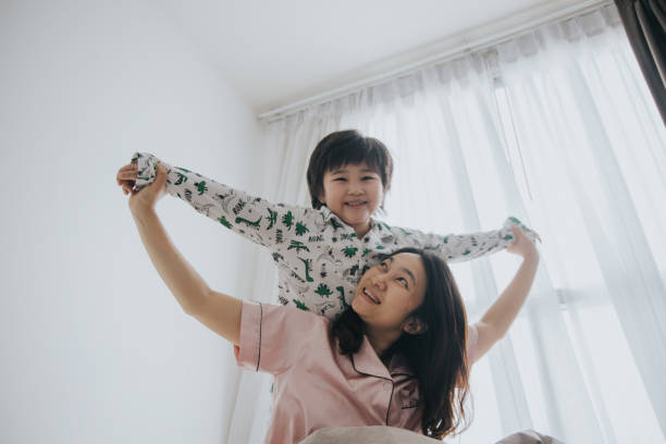 istock appy mother and her little son having fun playing together 1205546143