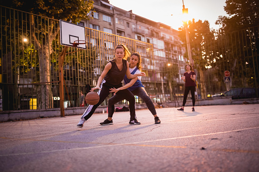 Group of females chatting after a leisure basketball game, outdoors. Belgrade, Serbia