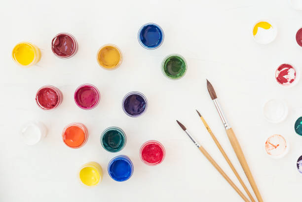 istock Acrylic paints and brushes at white background. Flat lay, top view 1205546827