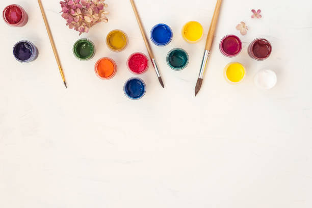 istock Acrylic paints and brushes at white background. Flat lay, top view 1205547606