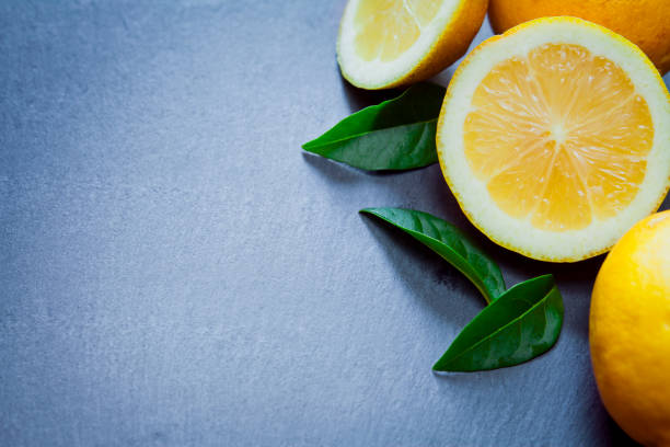 istock Fresh yellow citrus fruit -  lemon on the gray background -  copy space. 1205547875