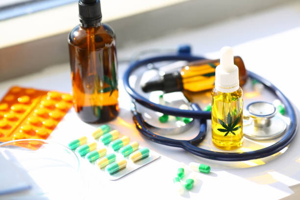 Medicine drugs and pills Close-up of cannabinoid oil in bottle and capsules lying on table. Medical marijuana for pain-relieving. Medication for sick patient. Treatment of diseases with organic and natural ingredients medical cannabis stock pictures, royalty-free photos & images