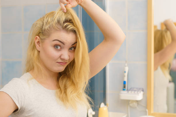 istock Female having problem with blonde hair 1205549289