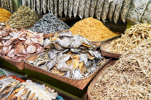 Close-up of heaps of dried and salted small fishes in bamboo baskets at the Central Wet Market in Iloilo, a local delicacy in the Philippines, Asia