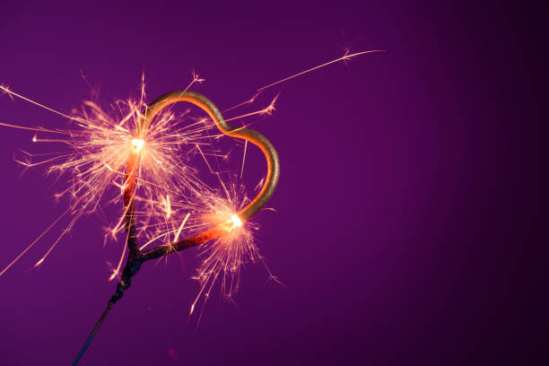 istock Burning sparkler in shape of heart 1205549522