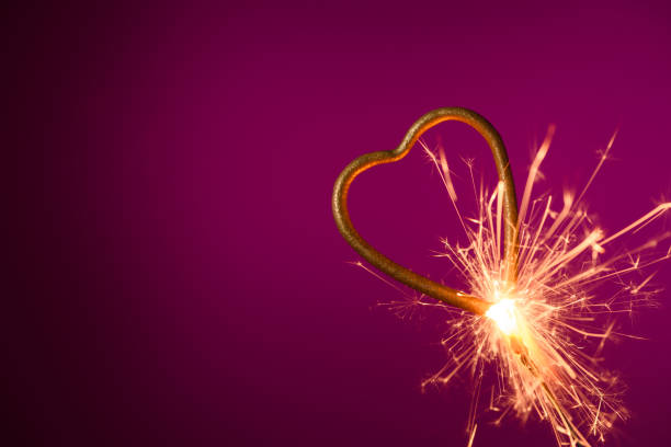 istock Burning sparkler in shape of heart 1205549583