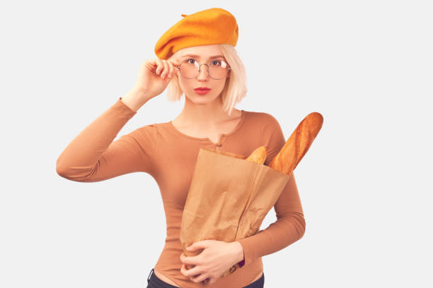 istock Young woman holding a bag with baguette 1205550652