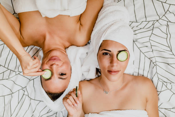 istock Two women with cucumber slices lying down in bed 1205551325