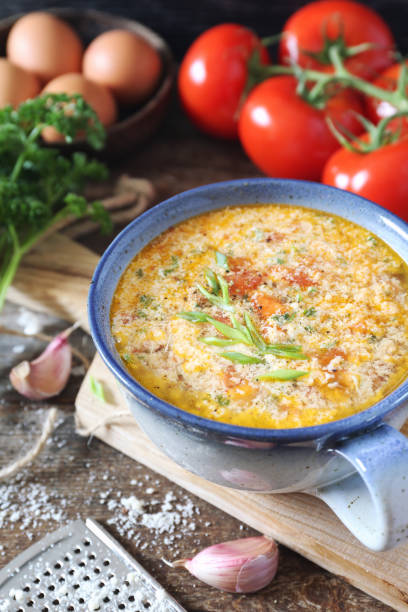 istock Italian food. Stracciatella tomato soup: parsley, eggs and parmesan cheese 1205551920