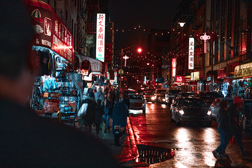 Chinatown street in New York\n\nNote for inspector: Honestly I don't see any issue with this image, people is blurred, and there are many signs that are ok because of the multiple logos and crowd rule. I even edited more the cars.