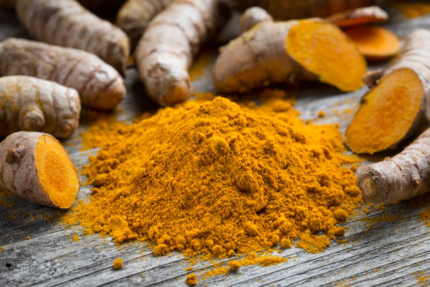 istock Curcuma longa, powder and rhizomes 1205552522