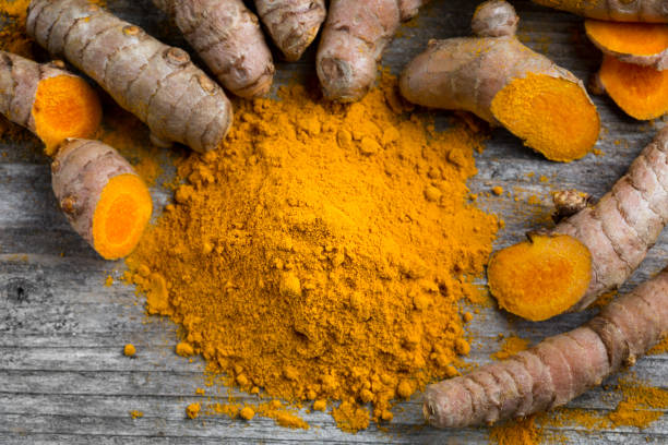 istock Curcuma longa, powder and rhizomes 1205552636
