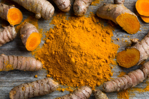 istock Curcuma longa, powder and rhizomes 1205552721