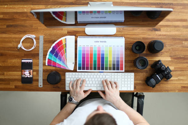 istock Male designer work at wooden table top view background 1205552750