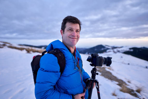 istock Tourist with camera in the snowy mountains 1205555967