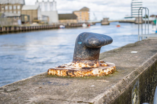 close up of metal mooring posts captured on the harbour wall - great yarmouth england norfolk river imagens e fotografias de stock