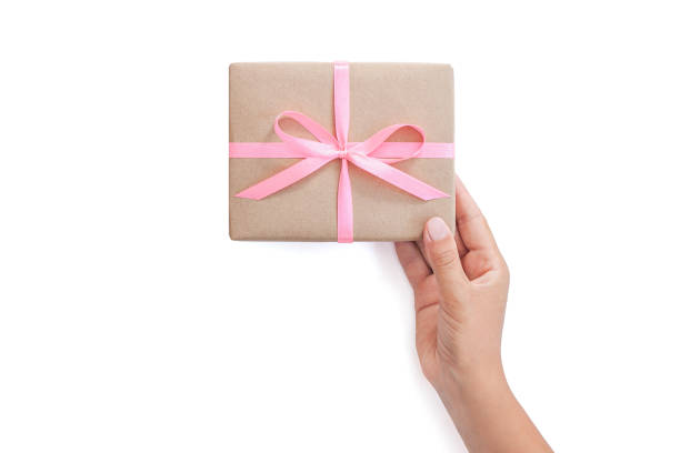 istock Female hands holding present box or gift box package in craft paper 1205558021
