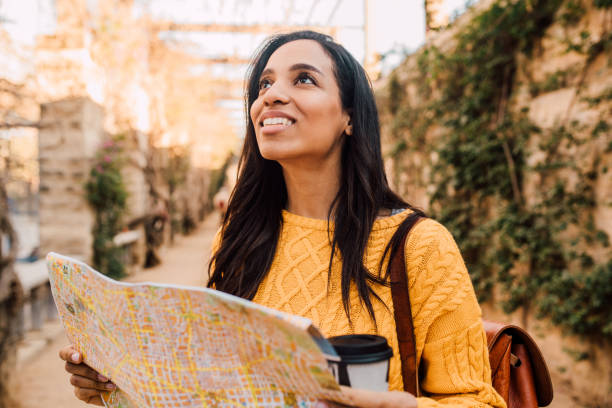 istock Beautiful tourist sightseeing using the city map 1205558766