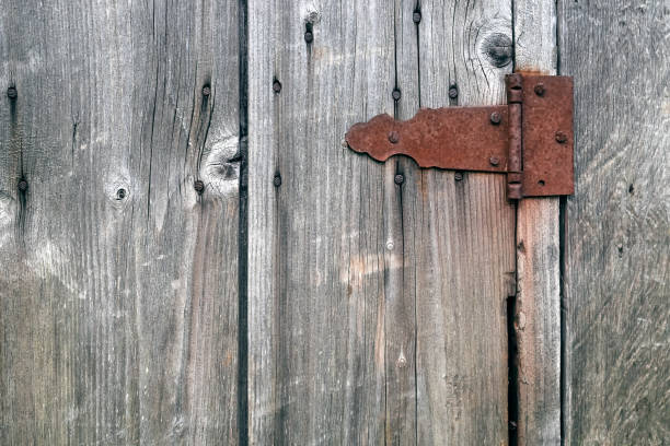 istock Old wooden not painted background, with rusty metal hinge 1205559592