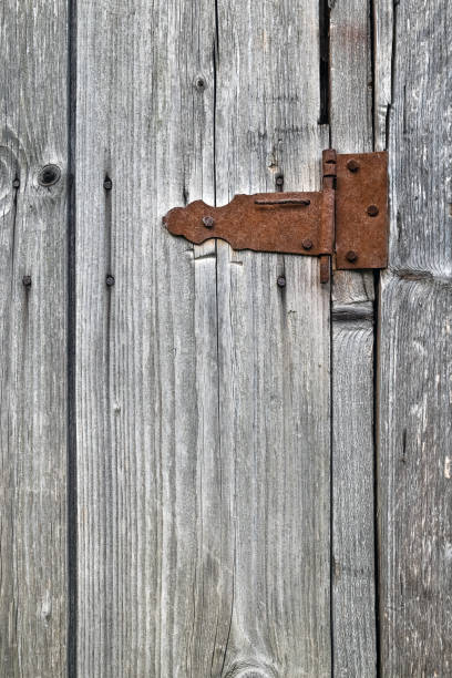 istock Old wooden not painted background, with rusty metal hinge 1205559636