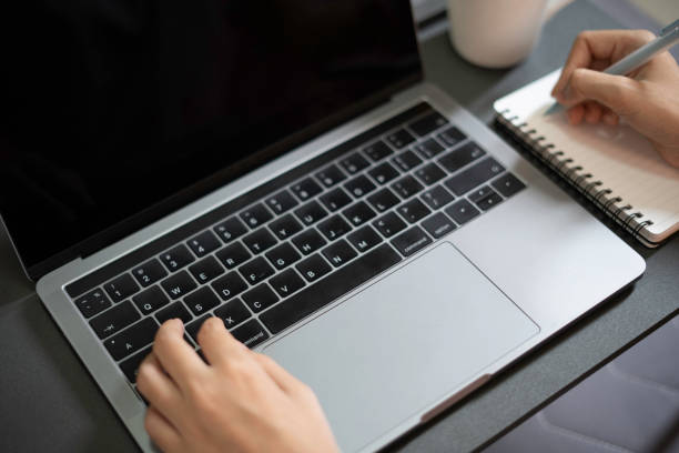 istock Closeup poerson woring on laptop at home office 1205559712
