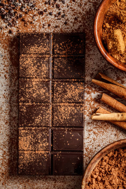 istock Chocolate bar and ingredients for making chocolate background. 1205560461